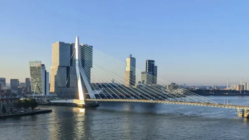The Erasmusbrug spanning the Nieuwe Maas beside Rotterdam waterfront buildings