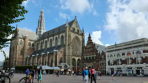 The Grote or St. Bavokerk and historic buildings on Haarlem's Grote Markt in daylight
